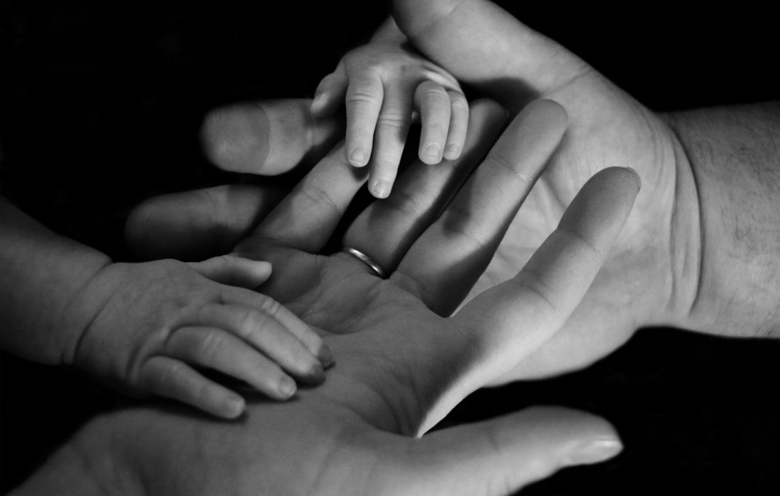 manos de bebe entrelazadas con adulto